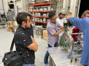 Team leader Jared Estrada watches mentor Shidong Kan receive Project Imua’s experiment.