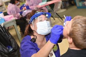 A student receiving care from a dental service provider.