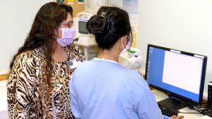 Donna Primiano-Holton, Kuakini Medical Center assistant vice president, and Micah Ellah Rose Eugenio