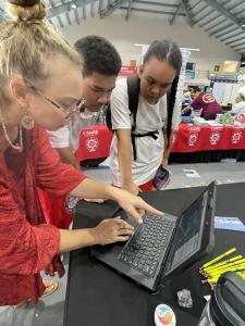 Kelley Anderson Tagarino shows the new viewer to students at the American Samoa conference.