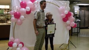 Councilmember Matt Weyer presenting a certificate to Luzader