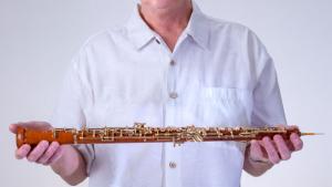 J. Scott Janusch holds an oboe made of Hawaiian kauila wood.