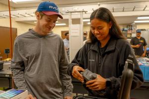 ENGT 107 students Avery Bryce and Tiala-Ann Kailianu-Carvalho inspect the Mavic 3 Multi-spectral dro