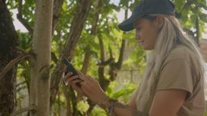 Second-year TEAM student Lana Frutoz uses a GPS receiver to collect a waypoint of a native tree. 