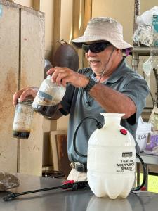 Hawaiʻi CC Assistant Professor Lew Nakamura mixes fermented plant juice and lactic acid bacteria.