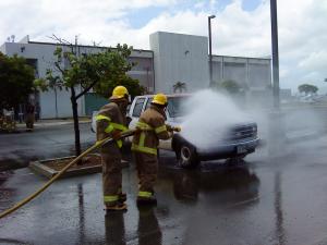 Fire students simulating a car fire scenario.