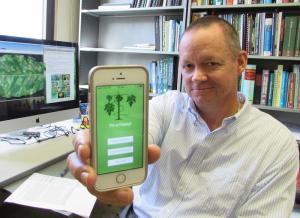 Dr. Scot Nelson shows the Pic-a-Papaya app.