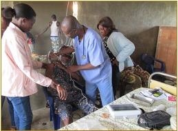 Dr. Ikuomola treats a patient in Nigeria in January 2015.