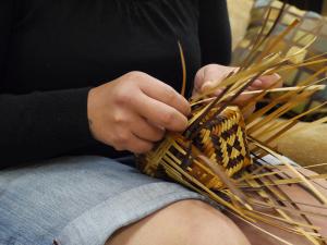 A basket weaver from the Eastern Band of Cherokee Indians weaves a river cane basket. 