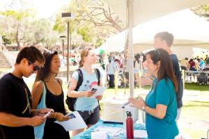 UHM representatives dispense info to Manoa Experience attendees.