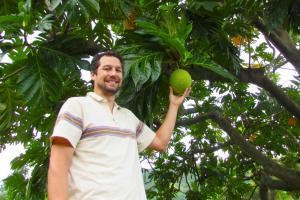 Noa Lincoln with breadfruit on the UH Manoa campus.