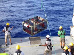 Researchers recover a trap after it landed on the bottom of the Mariana Trench. Credit: Paul Yancey