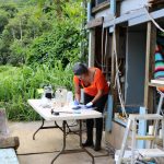 Dr. Kiana Frank tests dirt and water samples in her make shift lab at Kapuna Farms