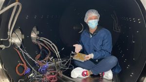 An Earth and planetary exploration technology student in a vacuum chamber.
