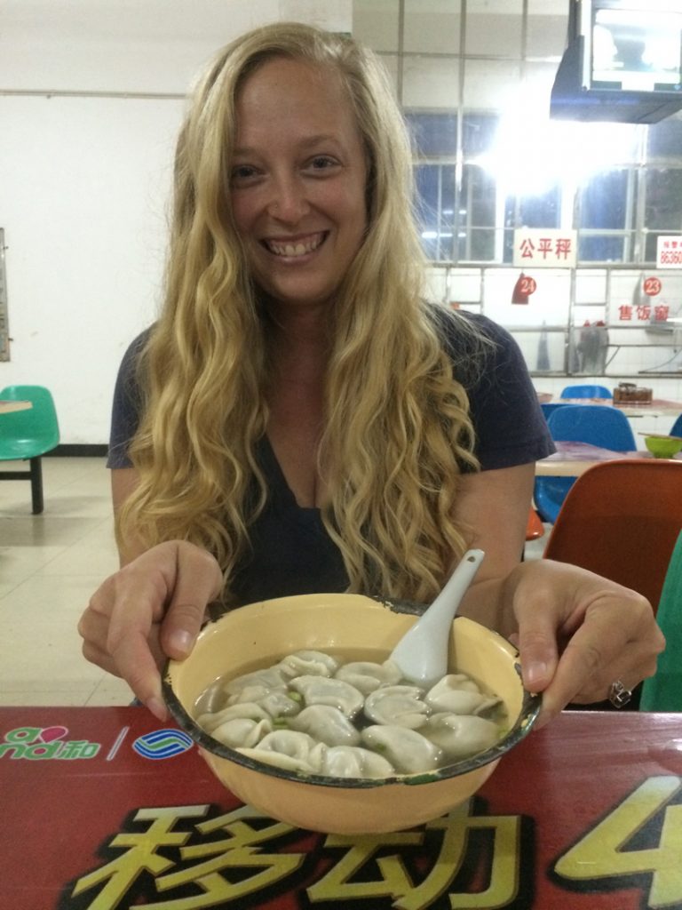 Kristyn Schuller with a bowl of dumplings