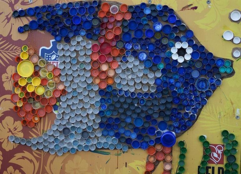 <p>Fig. 1. This art peice was made by children in 2013 and put on display at the “Eco-Friendly In the Park” Earth Day Expo near Riseley Field at Marine Corps Base Hawaiʻi. It is made of recycled bottle caps pasted together.</p>