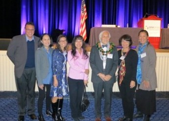 Dr. Yanagihara is surrounded by University of Hawai'i colleagues at the conference, on Dec. 1 in Maryland.