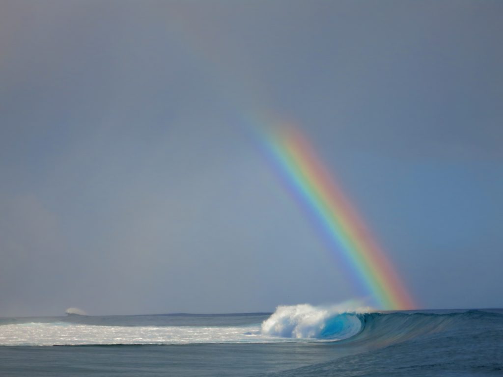Rainbow over the ocean waves