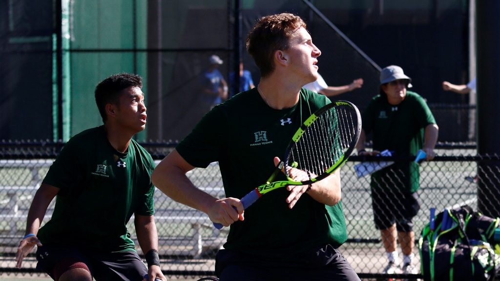 University of Hawaii at Manoa Men's Tennis doubles team preparing to receive a ball