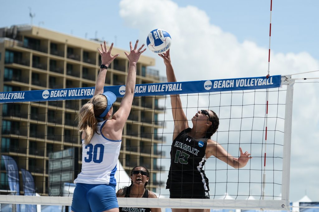 University of Hawaii at Manoa Women's Beach Volleyball Player spiking a ball