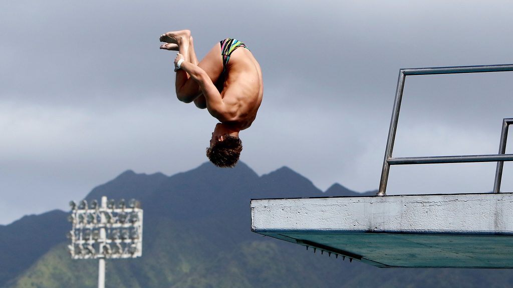 University of Hawaii at Manoa Men's Diving team member performing a dive.