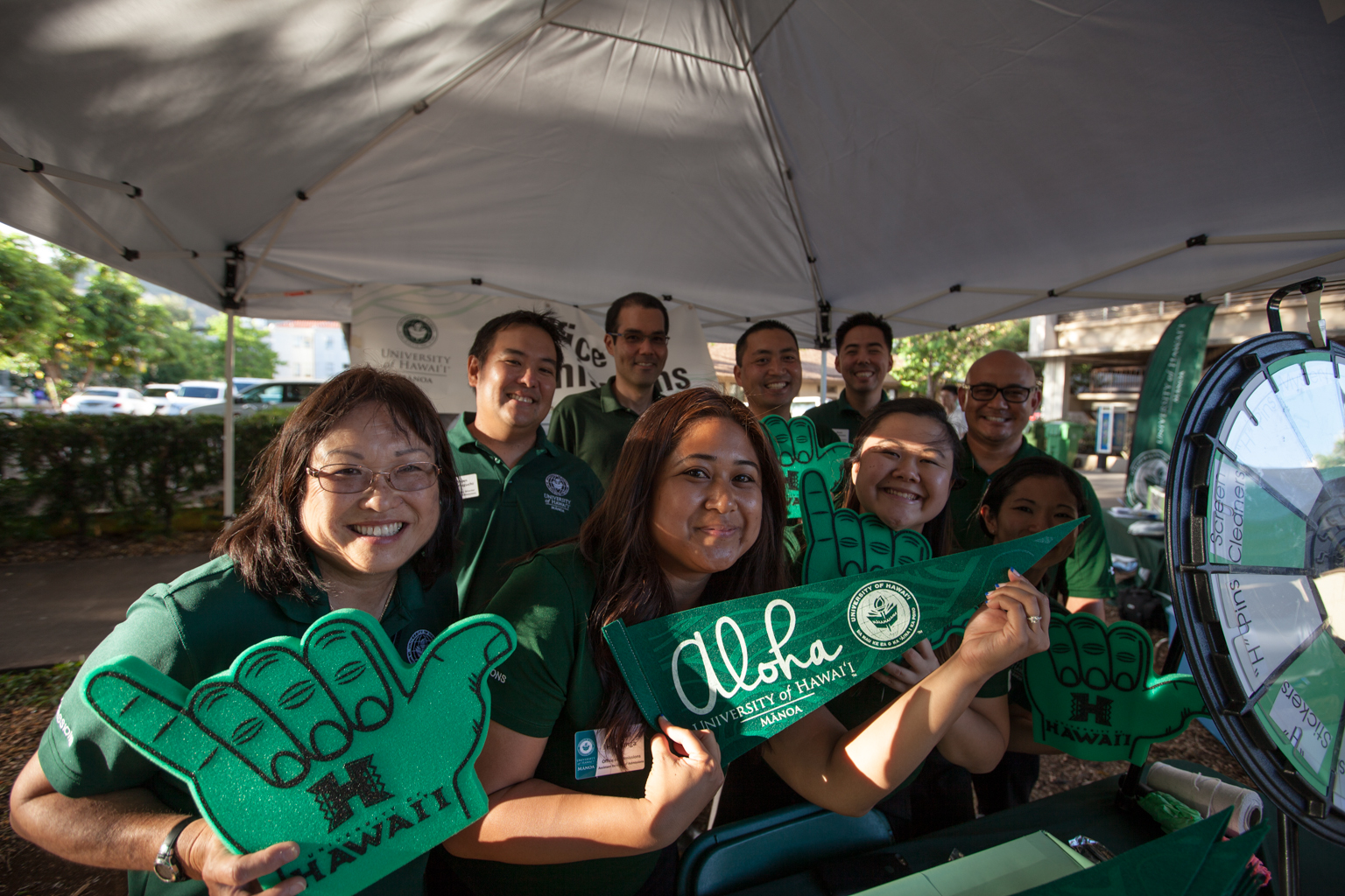 Faculty and staff at a booth at Welina Manoa.