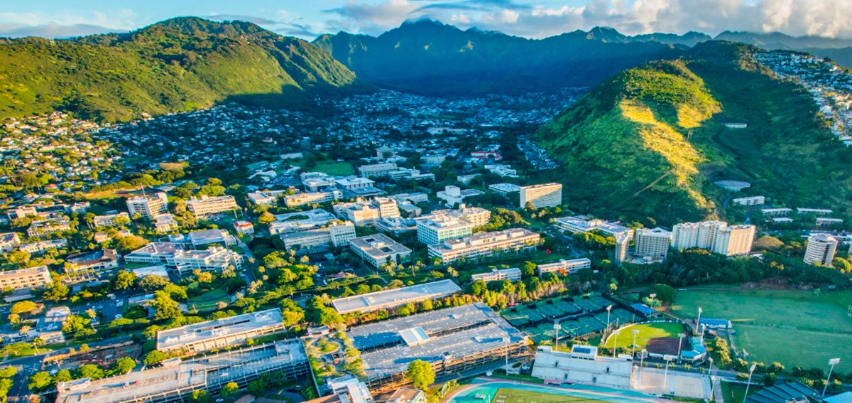 Aerial view of Manoa Valley in the early morning with the University of Hawaii at Manoa campus in the foreground