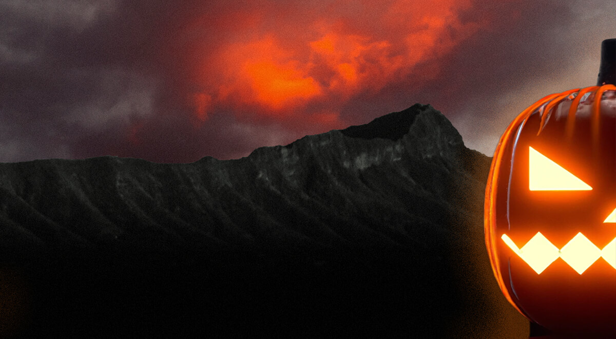 Halloween pumpkin with nightime Diamond Head and stormy sky in the background